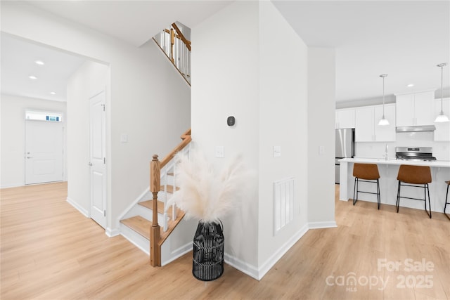 3110 Streamside Dr, Davidson, NC 28036 - stairway with wood finished floors, recessed lighting, and baseboards