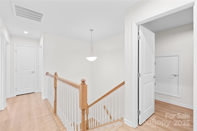 3110 Streamside Dr, Davidson, NC 28036 - hall with an upstairs landing, light wood finished floors, and recessed lighting
