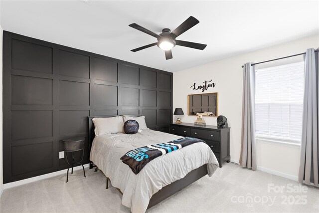 3110 Streamside Dr, Davidson, NC 28036 - bedroom featuring a decorative wall, light carpet, baseboards, and a ceiling fan