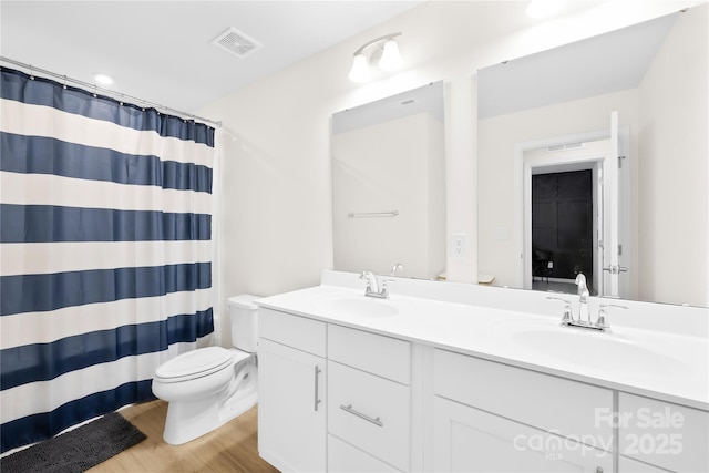 3110 Streamside Dr, Davidson, NC 28036 - full bathroom with toilet, wood finished floors, double vanity, and curtained shower