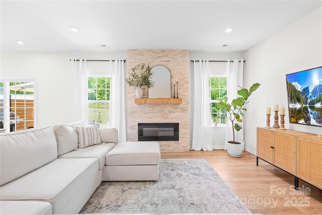 3110 Streamside Dr, Davidson, NC 28036 - living area with wood finished floors, a large fireplace, recessed lighting, and baseboards