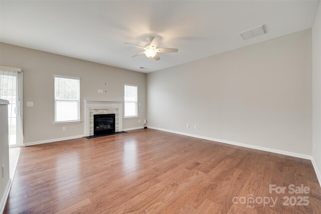 2169 Shady Pond Dr, Clover, SC 29710 - unfurnished living room featuring ceiling fan, wood finished floors, baseboards, and a fireplace with flush hearth