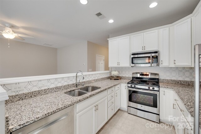 2169 Shady Pond Dr, Clover, SC 29710 - kitchen with appliances with stainless steel finishes, a sink, decorative backsplash, white cabinets, and recessed lighting