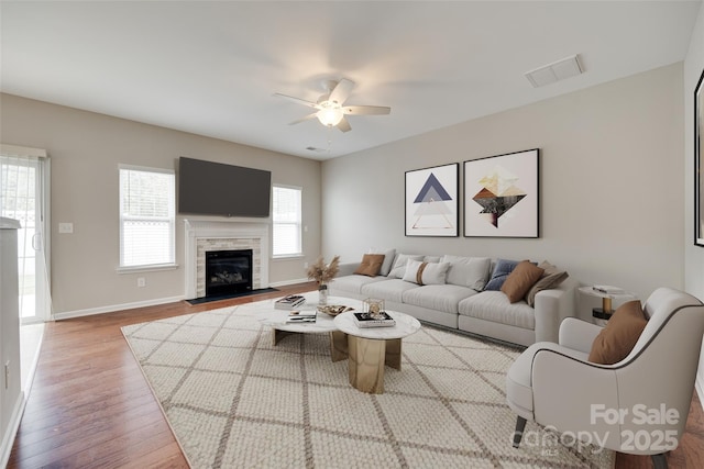 2169 Shady Pond Dr, Clover, SC 29710 - living area featuring a ceiling fan, wood finished floors, baseboards, and a fireplace with flush hearth