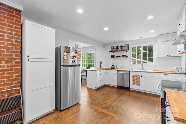 2536 Bancroft St, Charlotte, NC 28206 - kitchen featuring butcher block countertops, stainless steel appliances, a sink, dark wood finished floors, and white cabinets