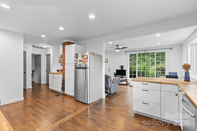 2536 Bancroft St, Charlotte, NC 28206 - kitchen featuring appliances with stainless steel finishes, butcher block counters, white cabinets, dark wood-style flooring, and recessed lighting