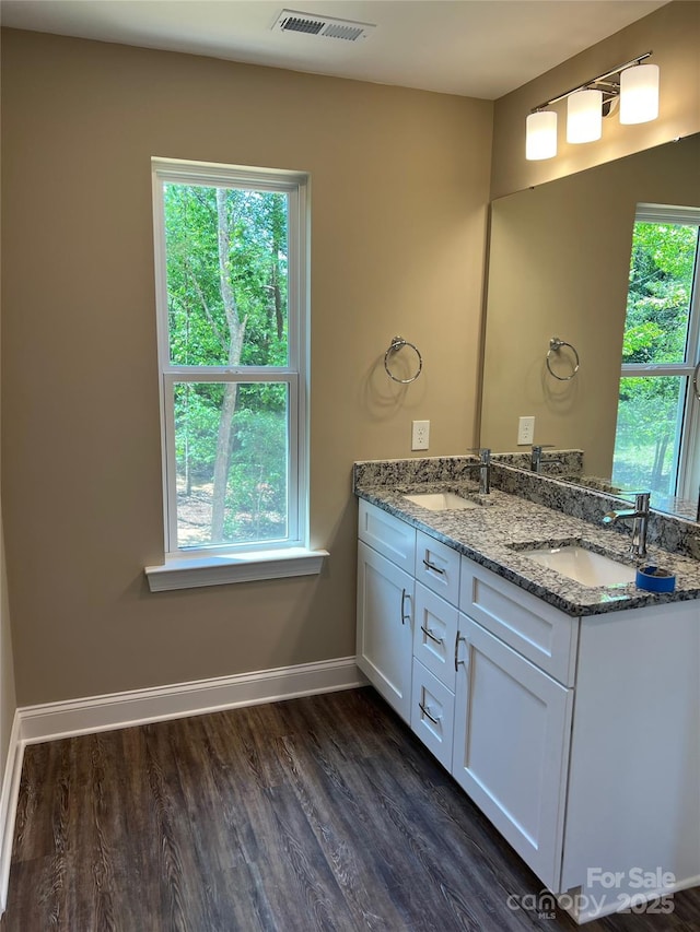 183 Pine Haven Rd, Statesville, NC 28677 - bathroom with double vanity, wood finished floors, and baseboards