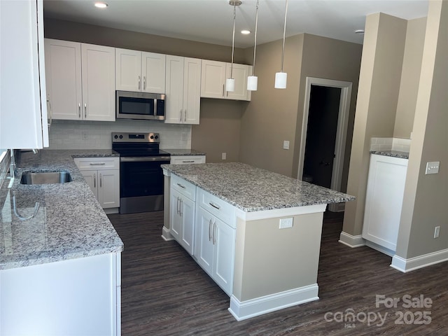 183 Pine Haven Rd, Statesville, NC 28677 - kitchen featuring stainless steel appliances, a sink, dark wood-style floors, tasteful backsplash, and white cabinets