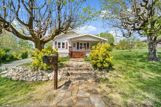 35 Amethyst St, Spruce Pine, NC 28777 - bungalow featuring a porch, a front yard, and stairs
