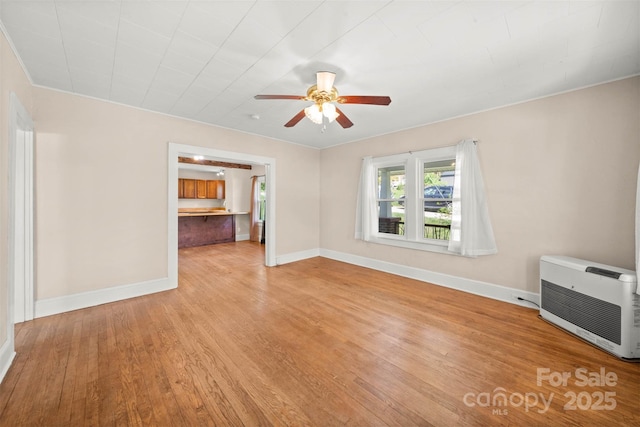 35 Amethyst St, Spruce Pine, NC 28777 - unfurnished living room with heating unit, a ceiling fan, light wood-style floors, and baseboards