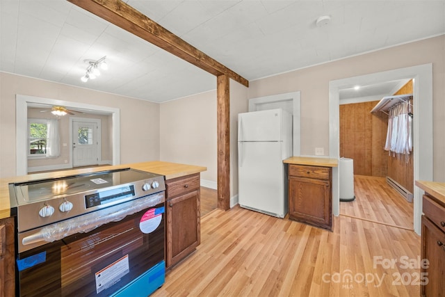 35 Amethyst St, Spruce Pine, NC 28777 - kitchen featuring freestanding refrigerator, stainless steel electric stove, light wood-style floors, a baseboard heating unit, and brown cabinetry