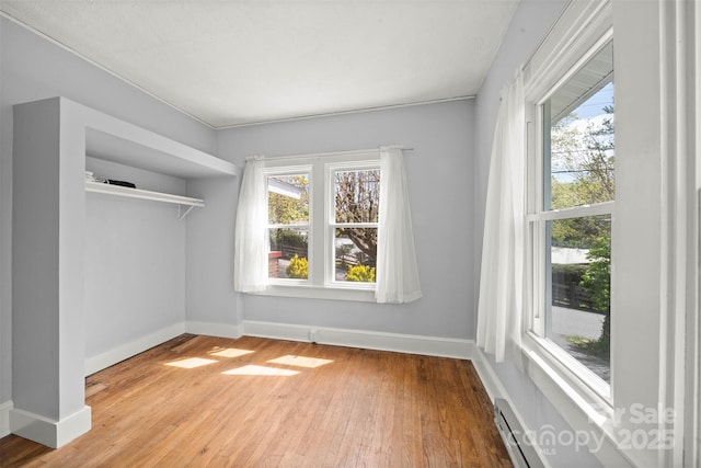 35 Amethyst St, Spruce Pine, NC 28777 - unfurnished bedroom featuring multiple windows, wood-type flooring, and baseboards