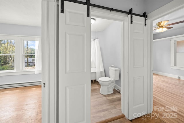 35 Amethyst St, Spruce Pine, NC 28777 - full bathroom with wood finished floors, baseboard heating, toilet, and a ceiling fan