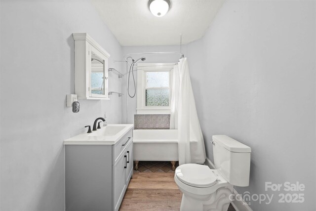35 Amethyst St, Spruce Pine, NC 28777 - bathroom featuring toilet, shower / bathtub combination with curtain, wood finished floors, and vanity