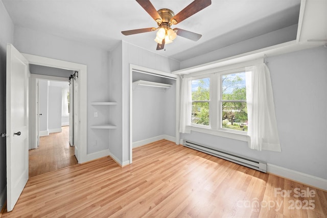 35 Amethyst St, Spruce Pine, NC 28777 - unfurnished bedroom with a baseboard heating unit, light wood-style floors, baseboards, a closet, and ceiling fan
