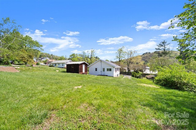 35 Amethyst St, Spruce Pine, NC 28777 - view of grassy yard with an outbuilding and a storage shed