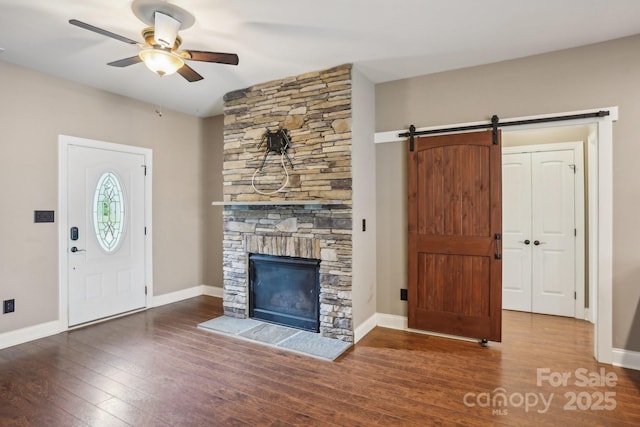 2021 Chantilly Ln, Salisbury, NC 28146 - entryway featuring ceiling fan, wood-type flooring, a stone fireplace, and baseboards