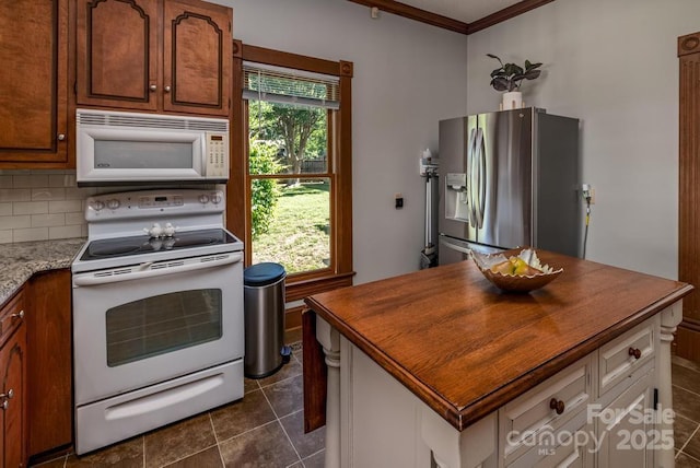 328 E Center Ave, Mooresville, NC 28115 - kitchen featuring white appliances, dark tile patterned floors, a kitchen island, decorative backsplash, and wooden counters