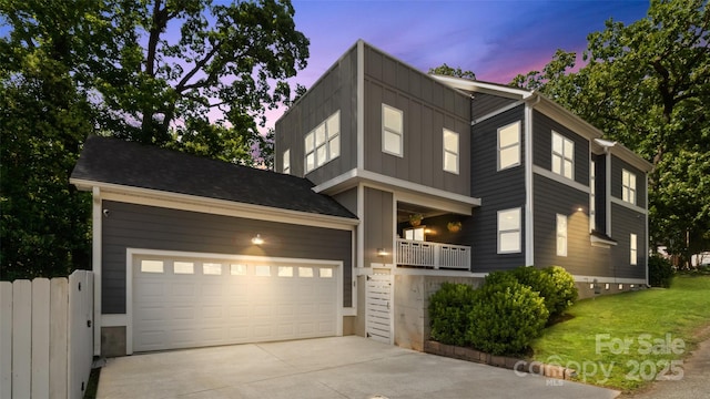 1446 Downs Ave, Charlotte, NC 28205 - modern home with concrete driveway, board and batten siding, a lawn, and an attached garage