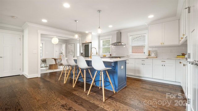 1446 Downs Ave, Charlotte, NC 28205 - kitchen featuring wall chimney range hood, crown molding, white cabinets, light countertops, and a breakfast bar area