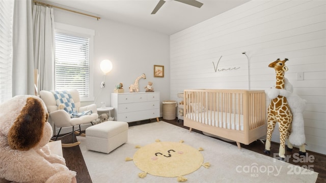 1446 Downs Ave, Charlotte, NC 28205 - bedroom with a crib, ceiling fan, and wood finished floors