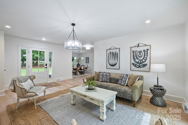 9520 Squirrel Hollow Ln, Charlotte, NC 28270 - living room with wood finished floors, a chandelier, baseboards, and recessed lighting