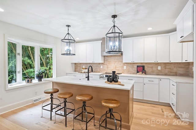 9520 Squirrel Hollow Ln, Charlotte, NC 28270 - kitchen featuring exhaust hood, light wood-style floors, stainless steel electric range oven, light countertops, and recessed lighting