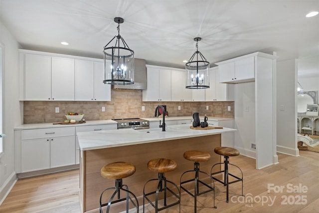 9520 Squirrel Hollow Ln, Charlotte, NC 28270 - kitchen featuring a sink, light wood-style floors, recessed lighting, white cabinets, and decorative backsplash