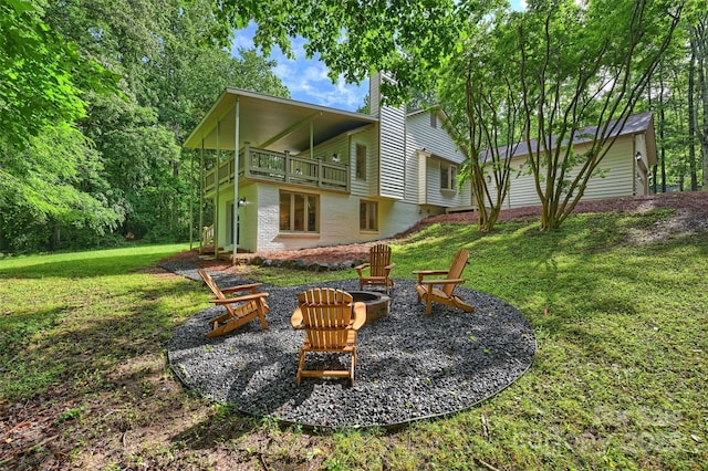9520 Squirrel Hollow Ln, Charlotte, NC 28270 - back of property featuring a fire pit, a yard, a balcony, and brick siding