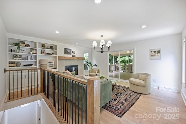 9520 Squirrel Hollow Ln, Charlotte, NC 28270 - living room featuring wood finished floors, a tile fireplace, a chandelier, recessed lighting, and baseboards