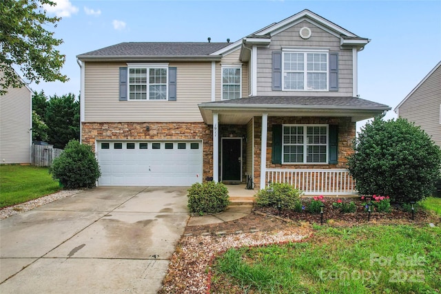 1911 Savannah Hills Dr, Matthews, NC 28105 - traditional-style house with covered porch, a garage, stone siding, and concrete driveway
