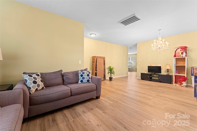 1911 Savannah Hills Dr, Matthews, NC 28105 - living area with light wood finished floors, a chandelier, and baseboards