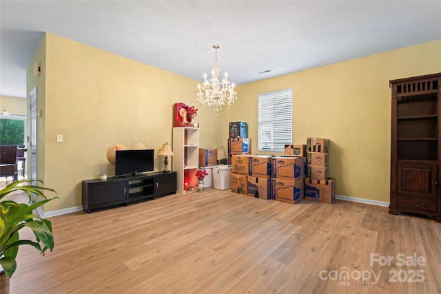 1911 Savannah Hills Dr, Matthews, NC 28105 - living room featuring wood finished floors, a chandelier, and baseboards