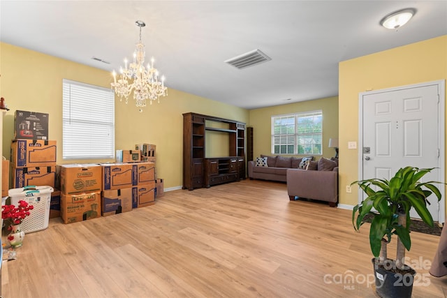 1911 Savannah Hills Dr, Matthews, NC 28105 - living room with wood finished floors, a chandelier, and baseboards