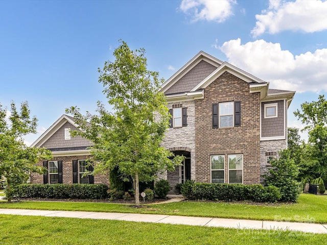 121 Enclave Meadows Ln, Matthews, NC 28104 - craftsman-style house with a front lawn, brick siding, and stone siding