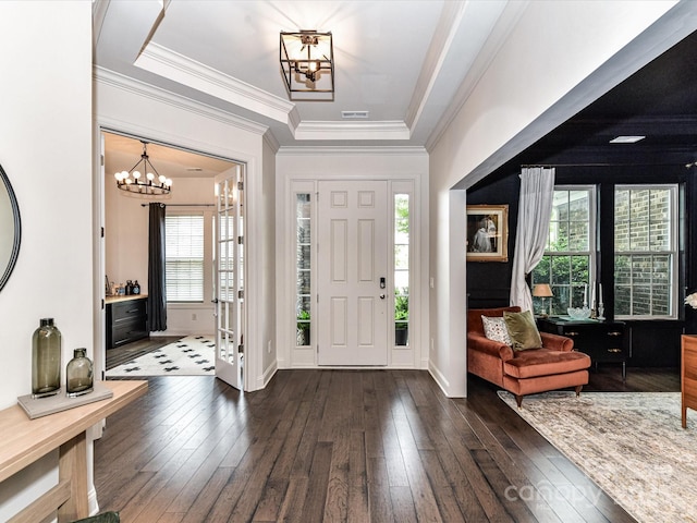 121 Enclave Meadows Ln, Matthews, NC 28104 - entrance foyer featuring a chandelier, dark wood finished floors, a raised ceiling, ornamental molding, and baseboards