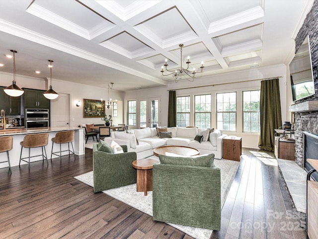 121 Enclave Meadows Ln, Matthews, NC 28104 - living area featuring a chandelier, a fireplace, dark wood-style floors, beam ceiling, and crown molding
