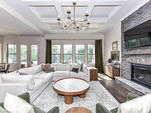 121 Enclave Meadows Ln, Matthews, NC 28104 - living area with wood finished floors, a chandelier, a stone fireplace, ornamental molding, and beam ceiling