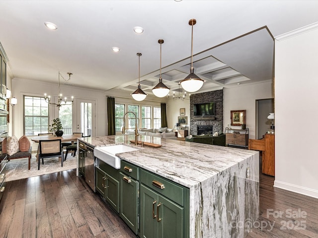 121 Enclave Meadows Ln, Matthews, NC 28104 - kitchen featuring green cabinets, a sink, ornamental molding, a fireplace, and appliances with stainless steel finishes