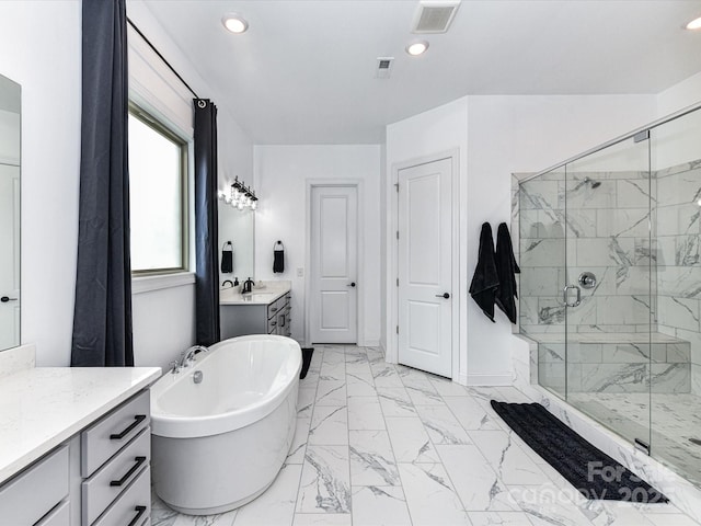 121 Enclave Meadows Ln, Matthews, NC 28104 - bathroom with marble look tiles, a marble finish shower, vanity, a freestanding bath, and recessed lighting