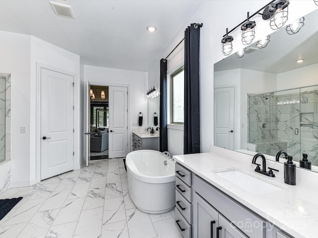 121 Enclave Meadows Ln, Matthews, NC 28104 - full bathroom with a marble finish shower, vanity, a freestanding tub, marble finish flooring, and recessed lighting