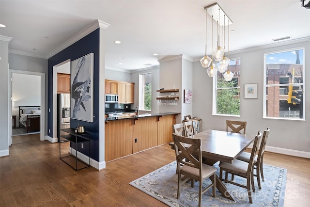 229 N Church St Unit 204, Charlotte, NC 28202 - dining space with ornamental molding, wood finished floors, recessed lighting, and baseboards
