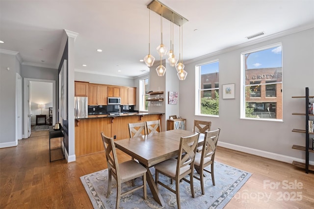 229 N Church St Unit 204, Charlotte, NC 28202 - dining space with ornamental molding, wood finished floors, baseboards, and recessed lighting
