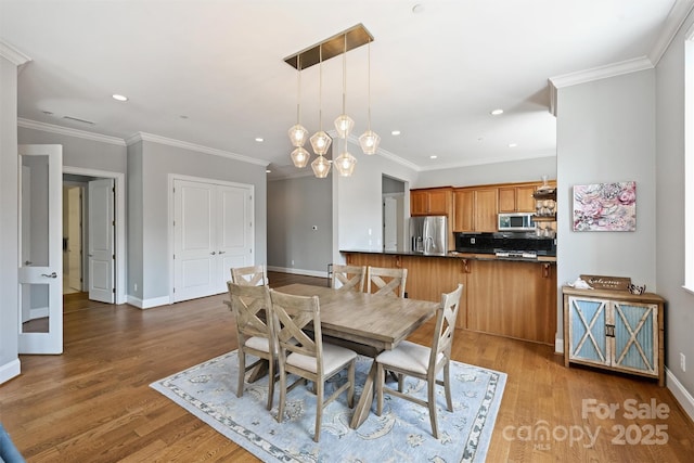 229 N Church St Unit 204, Charlotte, NC 28202 - dining room featuring recessed lighting, wood finished floors, baseboards, and ornamental molding