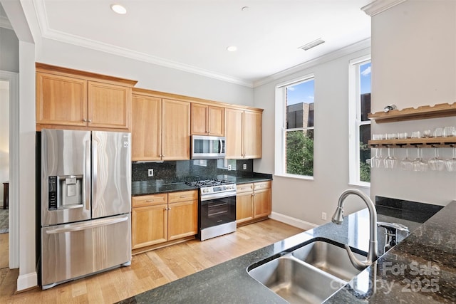 229 N Church St Unit 204, Charlotte, NC 28202 - kitchen with stainless steel appliances, a sink, light wood-type flooring, backsplash, and dark stone countertops