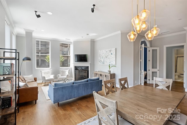 229 N Church St Unit 204, Charlotte, NC 28202 - dining area with wood finished floors, a high end fireplace, crown molding, a chandelier, and baseboards
