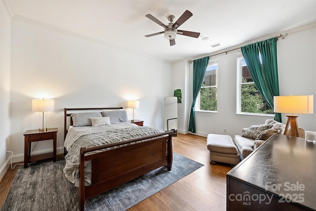 229 N Church St Unit 204, Charlotte, NC 28202 - bedroom with wood finished floors, ornamental molding, baseboards, and a ceiling fan