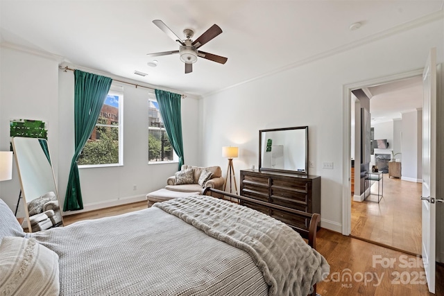 229 N Church St Unit 204, Charlotte, NC 28202 - bedroom featuring wood finished floors, baseboards, crown molding, and ceiling fan