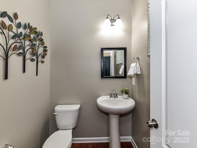 7325 Overmountain Dr, Rock Hill, SC 29732 - half bathroom with toilet, wood finished floors, a sink, and baseboards