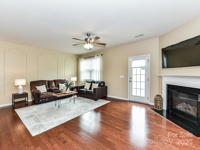 7325 Overmountain Dr, Rock Hill, SC 29732 - living area with healthy amount of natural light, dark wood-type flooring, ceiling fan, and a fireplace with flush hearth